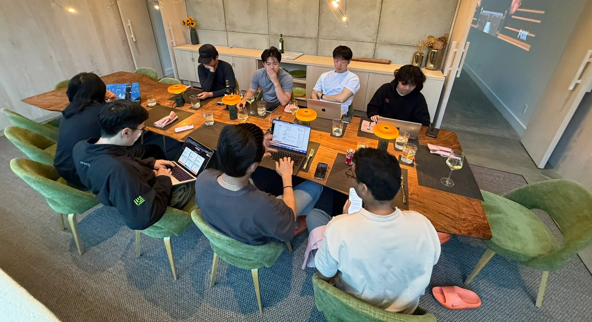 The team working on the app during dinner at the offsite